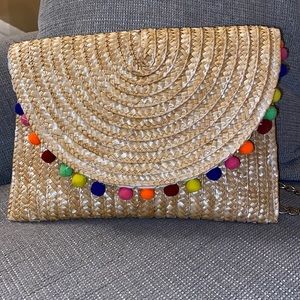 Wicker envelope shoulder bag with pom poms and chain measures 8x12 inches